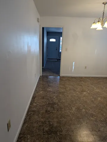 wooden floor in an empty room with a mirror