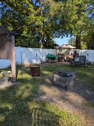 a backyard of a house with oven and a garden