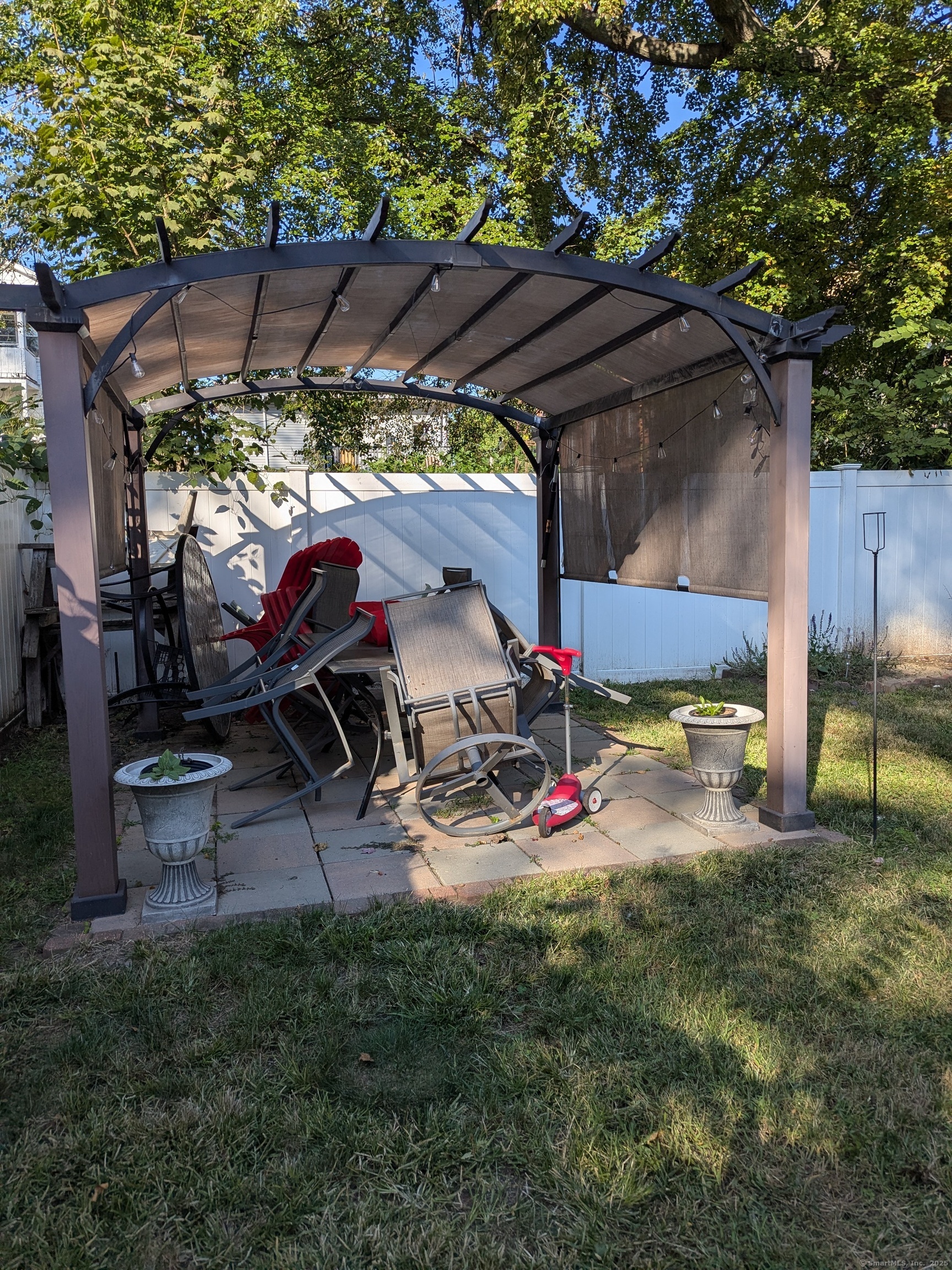 151 Enfield Street Hartford, CT 06112 - Photo 6 of 35 a view of a backyard with table and chairs under an umbrella