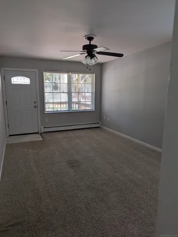 an empty room with a empty space and a ceiling fan