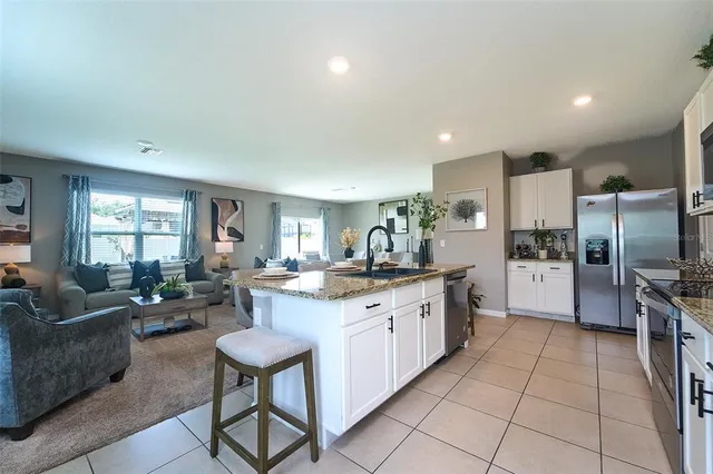 a kitchen with stainless steel appliances granite countertop a sink and a stove