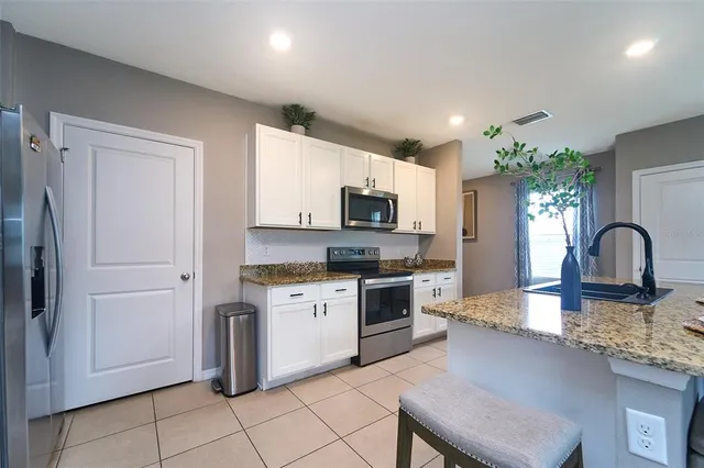 a picture of a living room with a potted plant