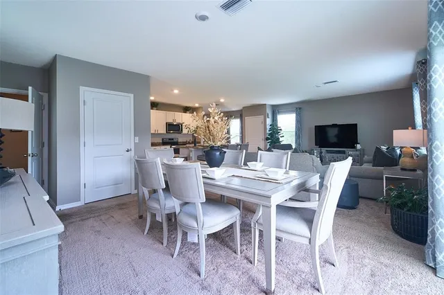 a view of a livingroom with furniture and a hallway