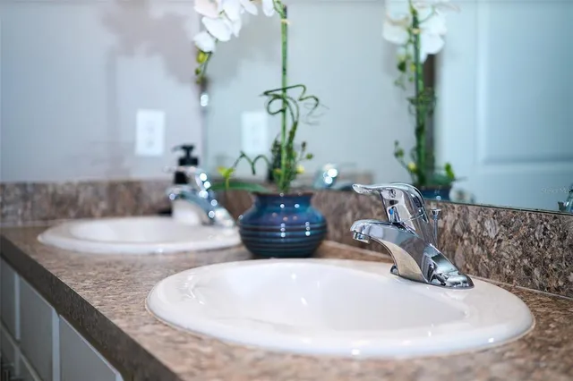 a bathroom with a granite countertop toilet sink and mirror