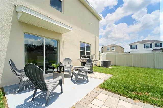 a view of a porch with furniture and a yard