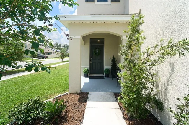 a front view of a house with a garden