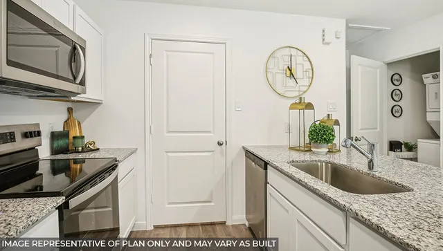 a kitchen with stainless steel appliances granite countertop a sink and a stove
