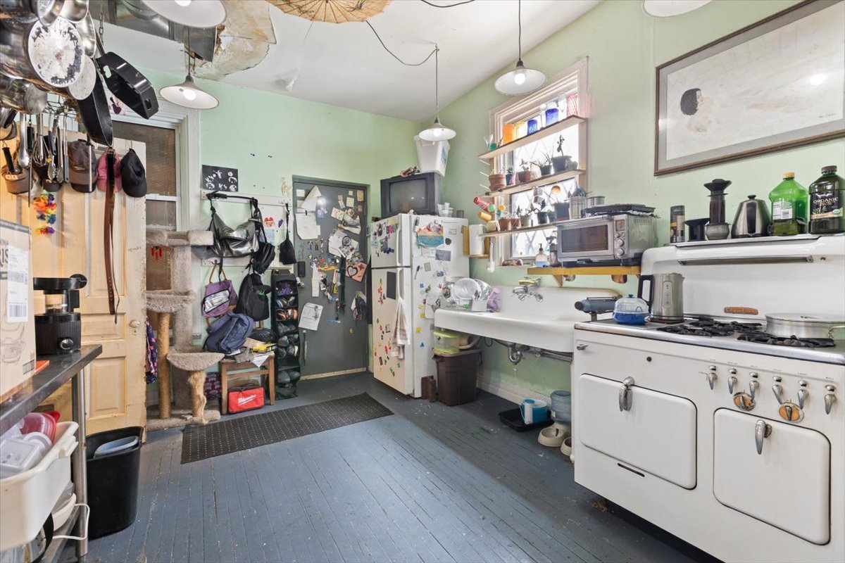 2605 West Division Street Chicago, IL 60622 - Photo 12 of 28 a kitchen filled with white cabinets and wooden floor