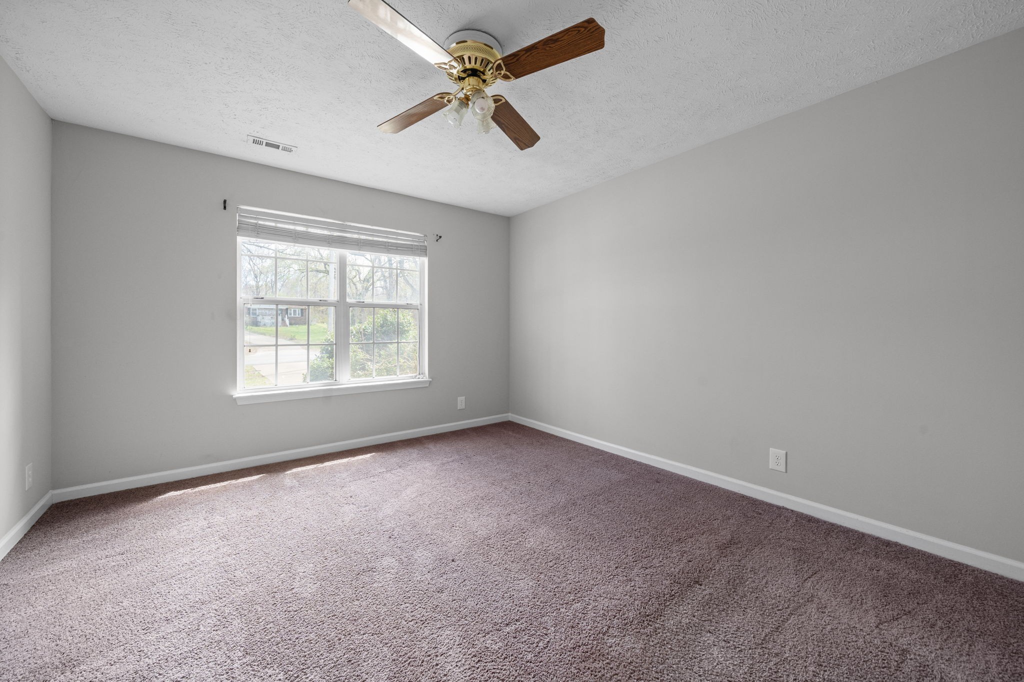 9193 Pembroke Oak Grove Road Oak Grove, KY 42262 - Photo 11 of 18 an empty room with a window and a fan