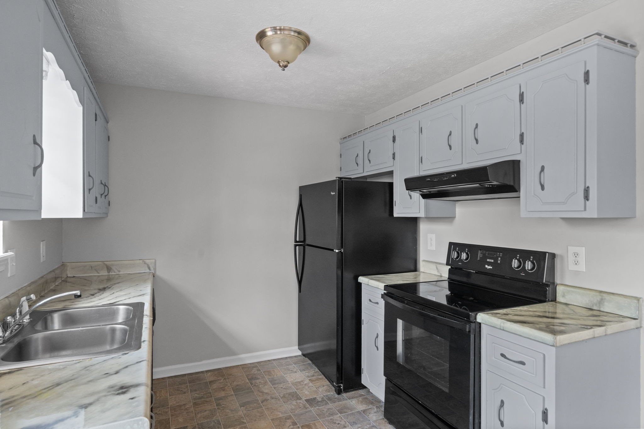 9193 Pembroke Oak Grove Road Oak Grove, KY 42262 - Photo 8 of 18 a kitchen with a sink stove and refrigerator