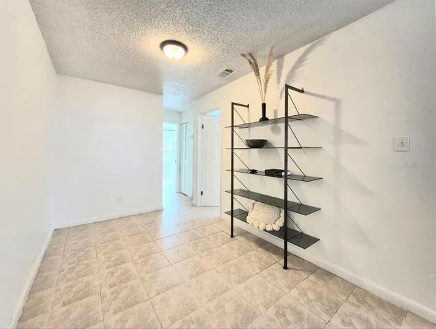 a view of a hallway with wooden cabinet and entryway