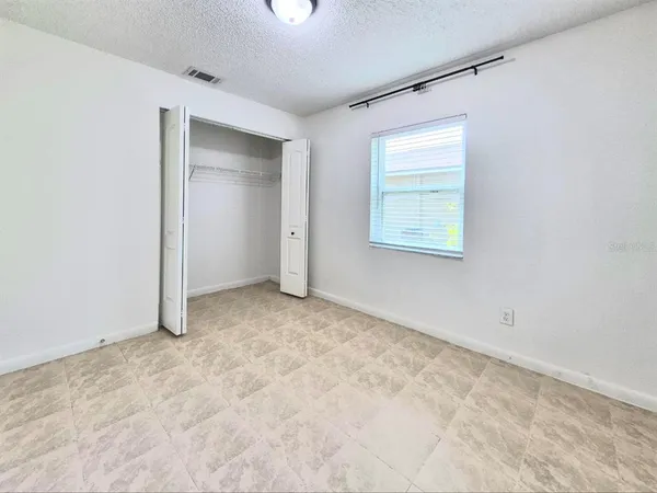 an empty room with closet area
