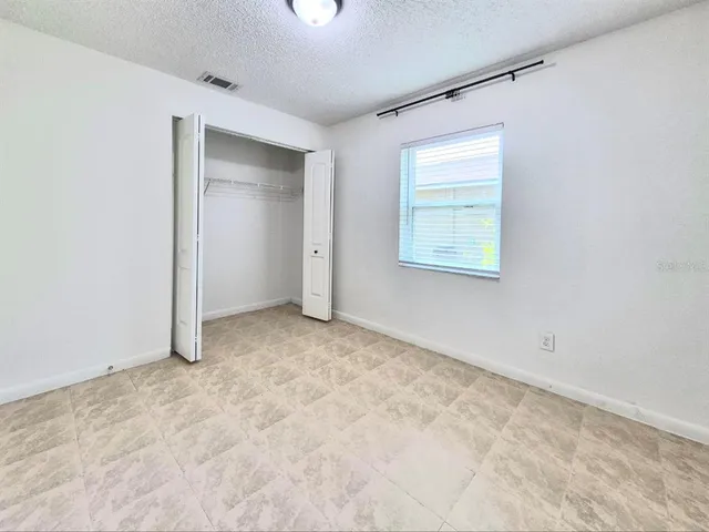 an empty room with closet area