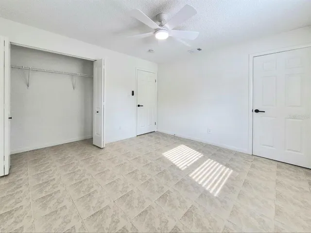 a view of a livingroom with a ceiling fan and window