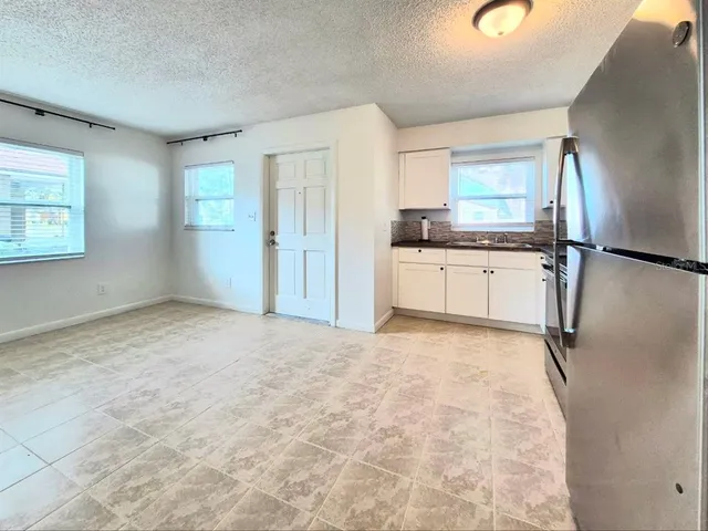 a kitchen with stainless steel appliances a stove a microwave and a refrigerator