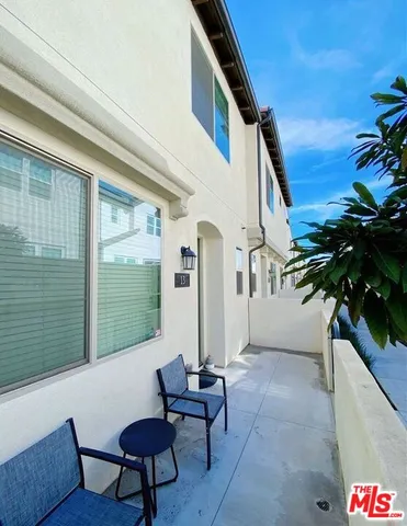 a balcony with furniture and a gate