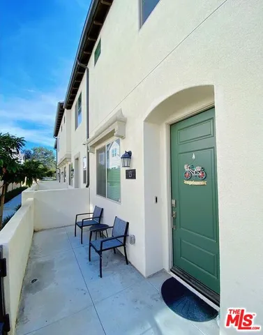 a living room with furniture and kitchen view