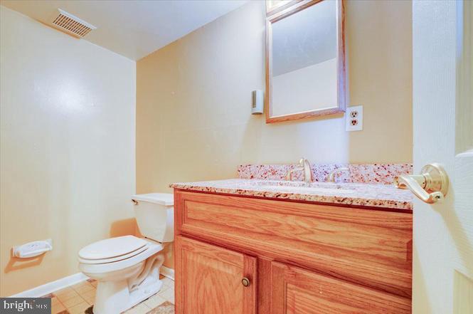 219 Fairview Avenue Lawnside, NJ 08045 - Photo 17 of 21 a bathroom with a granite countertop toilet sink and mirror