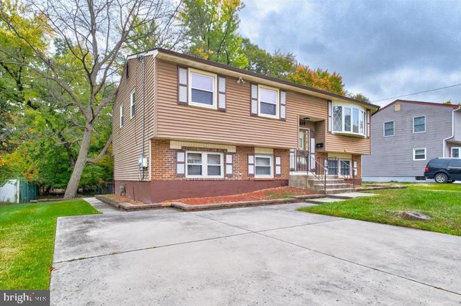 219 Fairview Avenue Lawnside, NJ 08045 - Photo 2 of 21 a front view of a house with a yard and garage