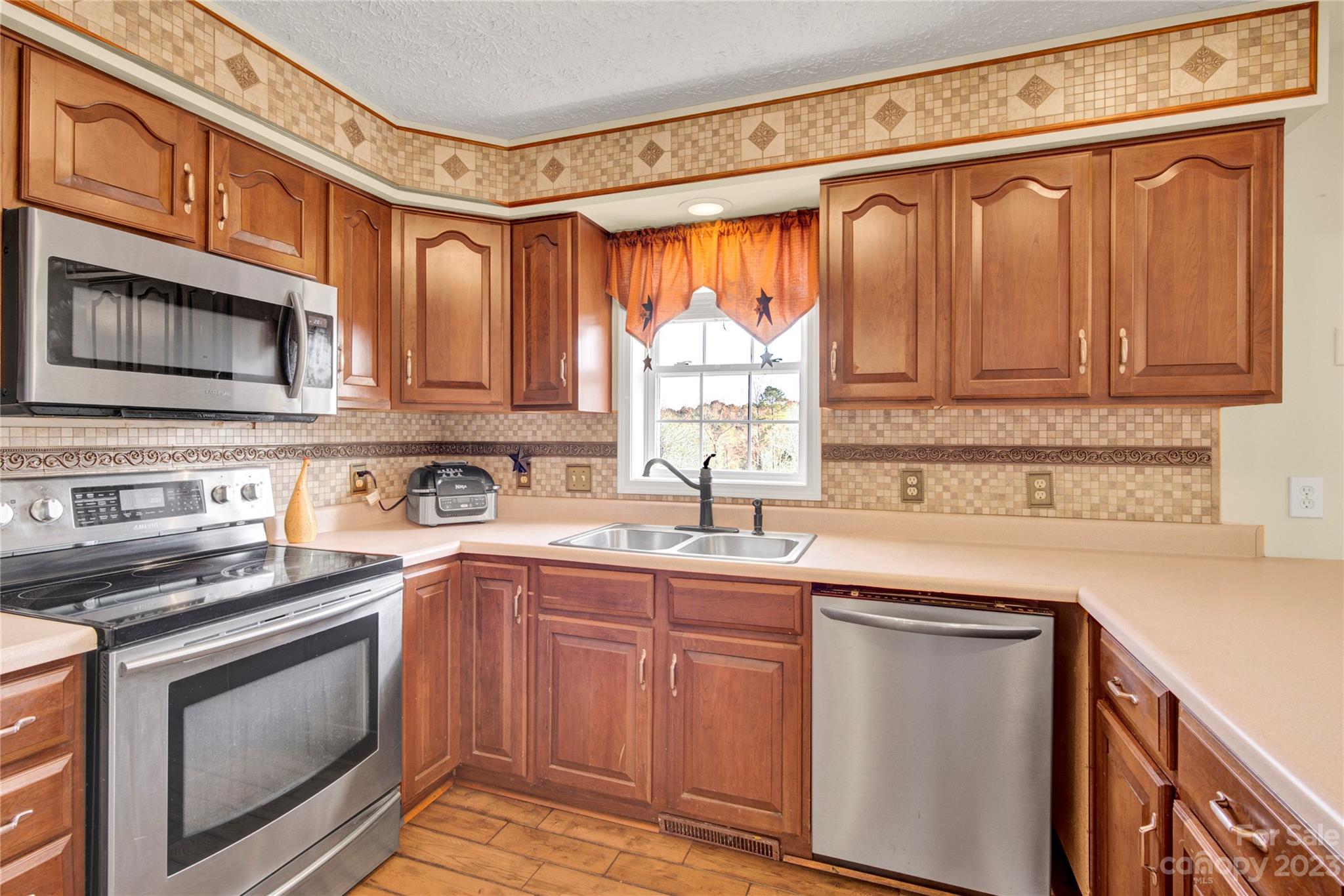 307 Rupard Road Statesville, NC 28625 - Photo 10 of 36 a kitchen with stainless steel appliances granite countertop a sink a stove a microwave and cabinets