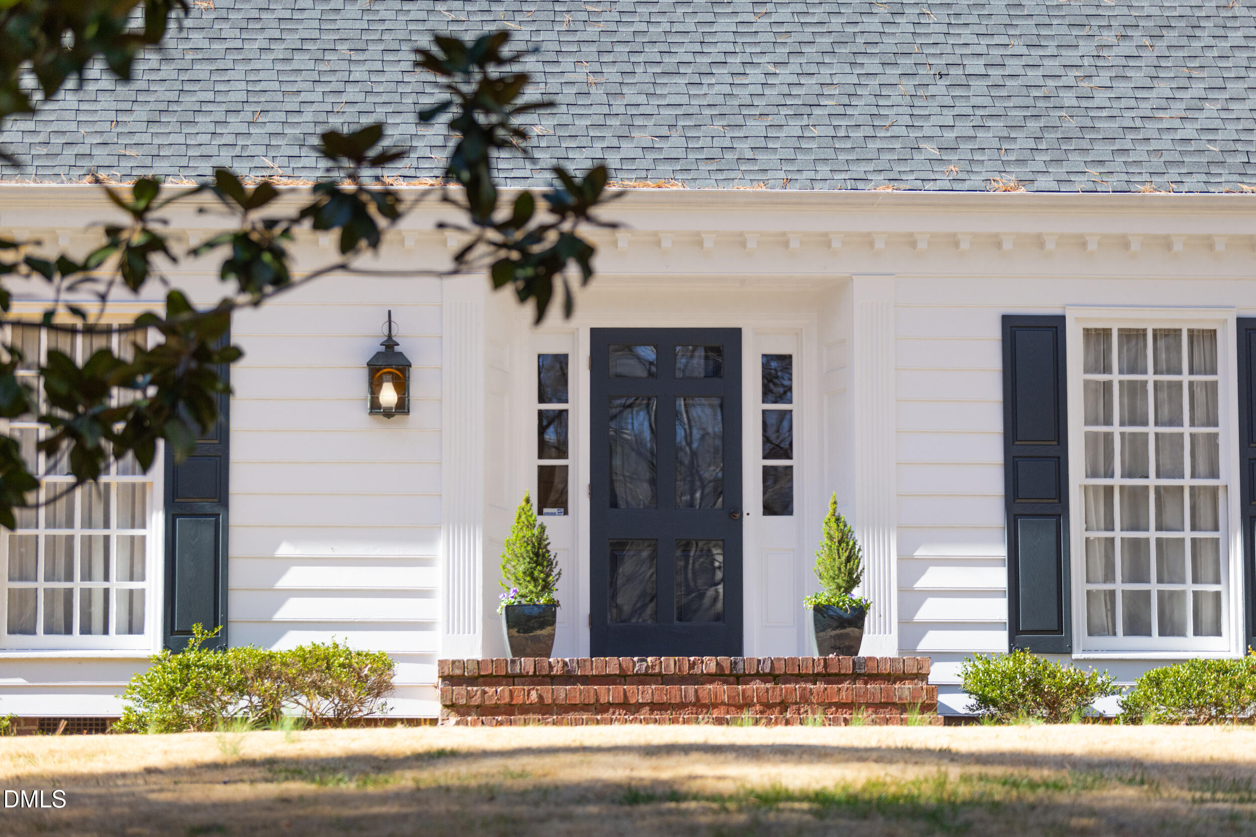 a view of a house with potted plants