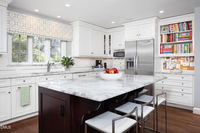 a kitchen with appliances a sink and cabinets
