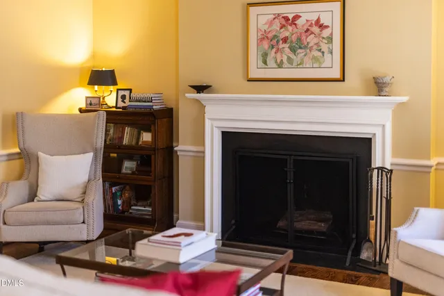 a view of a hallway with wooden floor and dining room view