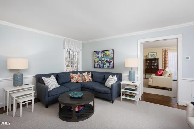 a view of a dining room with furniture and a potted plant