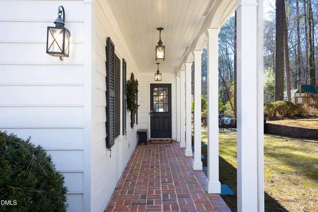 a bedroom with a large bed and paintings on the wall