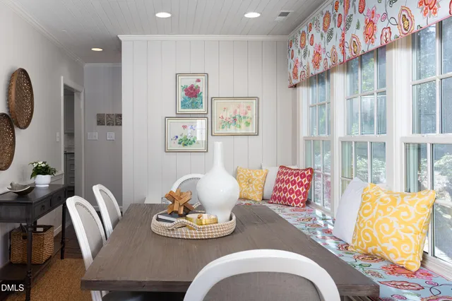 a bedroom with a bed and a lamp on dresser