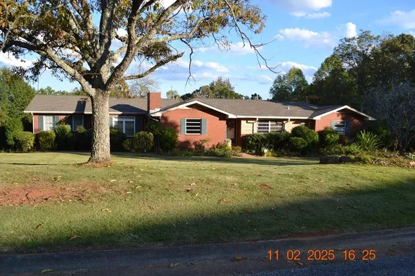 a view of a fountain in front of a house