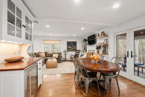 a dining room with furniture and wooden floor