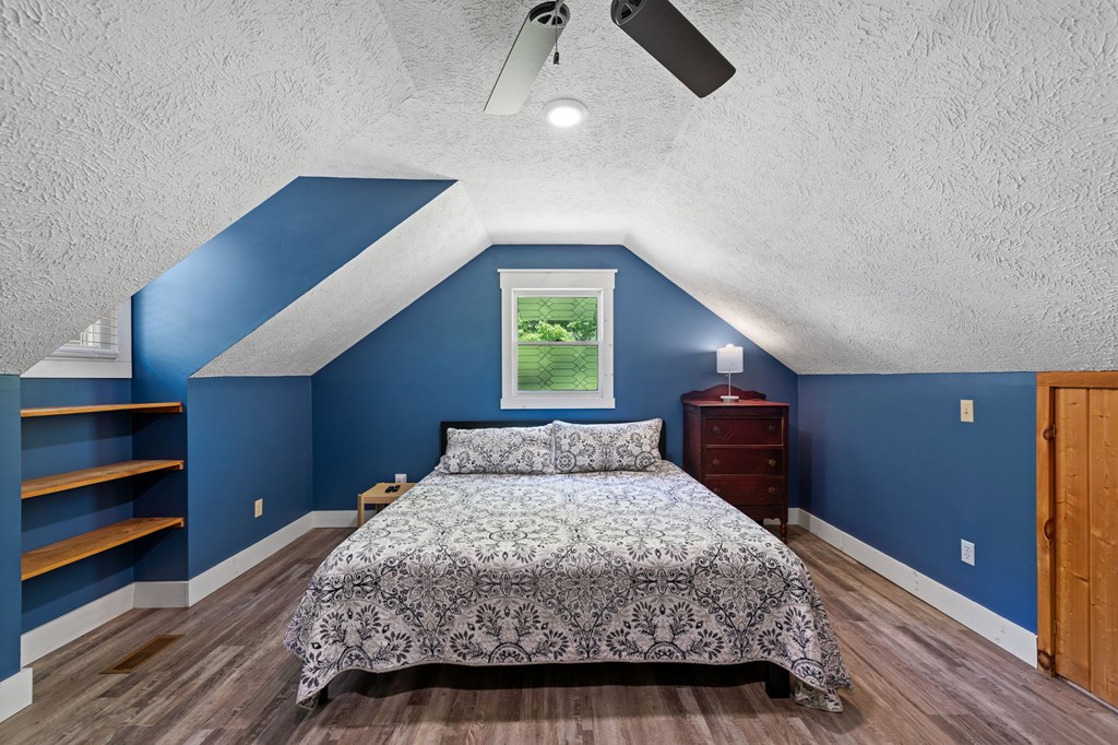 760 River Bend Lane Blue Ridge, GA 30513 - Photo 41 of 101 a bedroom with a large bed and a chandelier