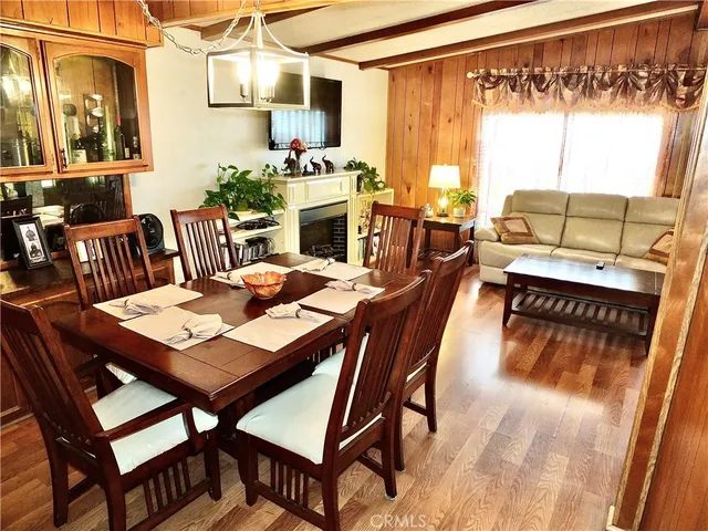 a dining room with furniture and wooden floor