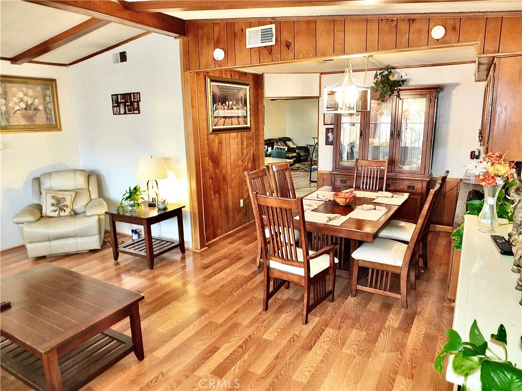 2601 East Victoria Street, Unit 439 Rancho Dominguez, CA 90220 - Photo 15 of 32 a dining room with furniture and wooden floor