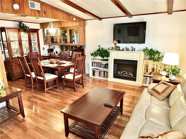 a outdoor space with furniture a flat screen tv and a fireplace