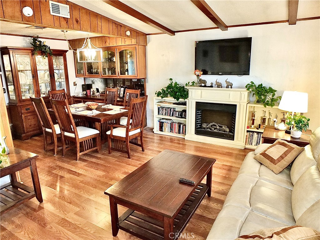 2601 East Victoria Street, Unit 439 Rancho Dominguez, CA 90220 - Photo 18 of 32 a living room with furniture a flat screen tv and a fireplace