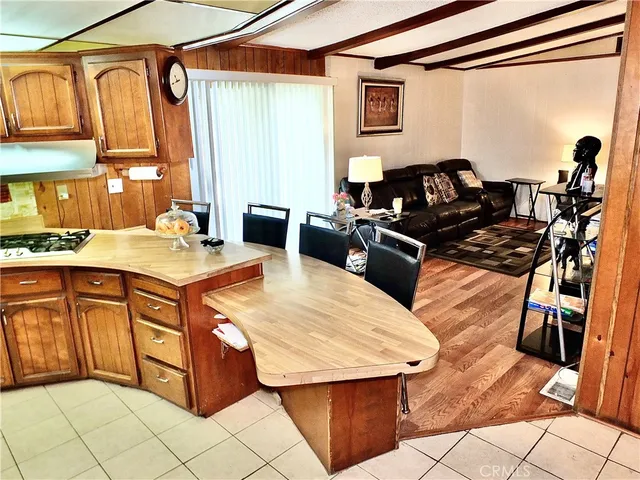 a kitchen with a stove a sink a microwave and a refrigerator