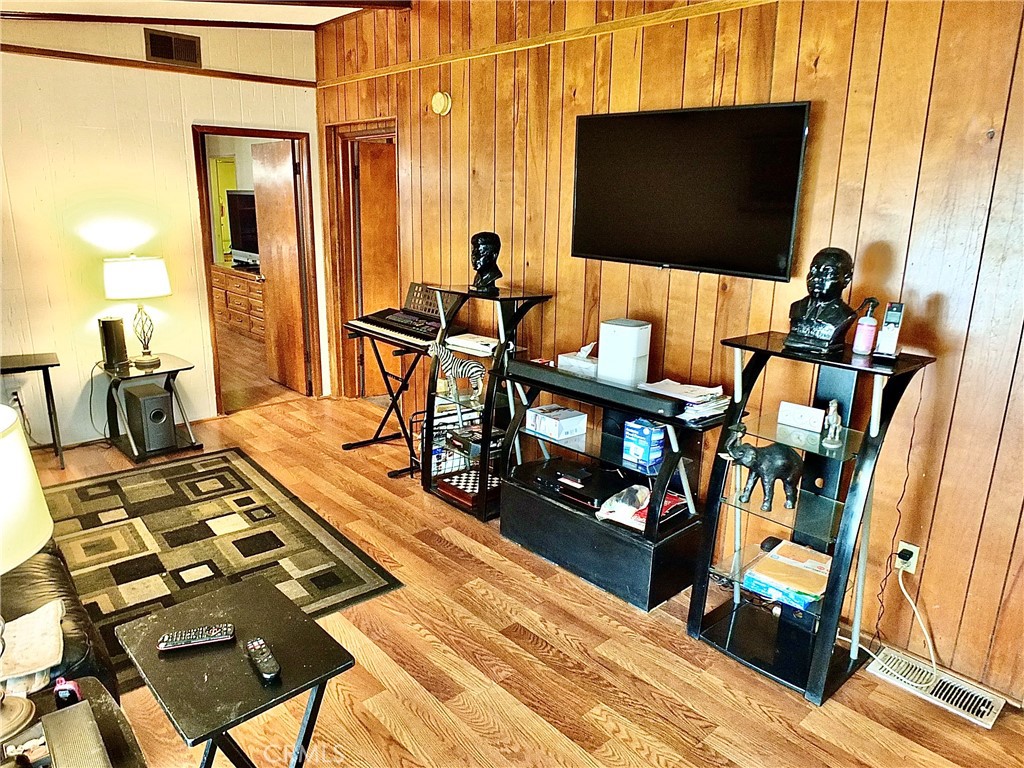 2601 East Victoria Street, Unit 439 Rancho Dominguez, CA 90220 - Photo 25 of 32 a living room with furniture and a flat screen tv