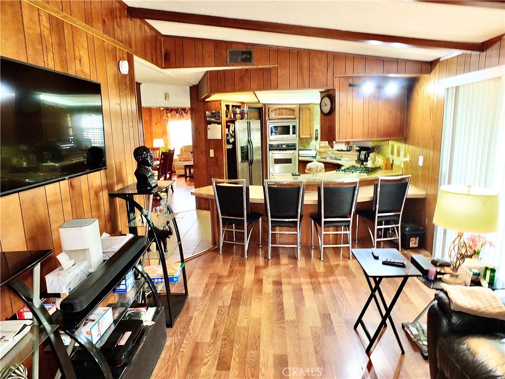 2601 East Victoria Street, Unit 439 Rancho Dominguez, CA 90220 - Photo 26 of 32 a dining hall with lots of tables a chairs and kitchen view