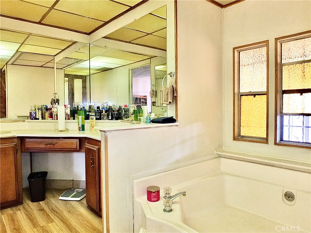 2601 East Victoria Street, Unit 439 Rancho Dominguez, CA 90220 - Photo 31 of 32 a bathroom with a tub a sink and a window