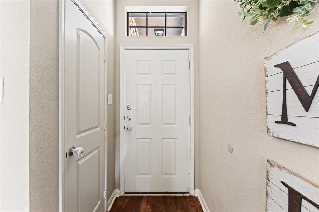 10313 Condor Loop Waco, TX 76708 - Photo 9 of 33 Wood-finish flooring, white paneled door, and a transom window above the entry door