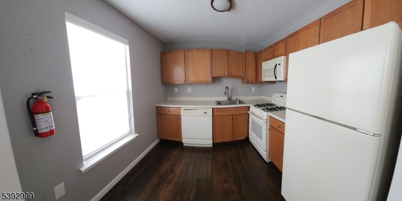 532 Great Beds Court, Unit 532 Perth Amboy, NJ 08861 - Photo 3 of 13 a kitchen with a white stove top oven sink and window