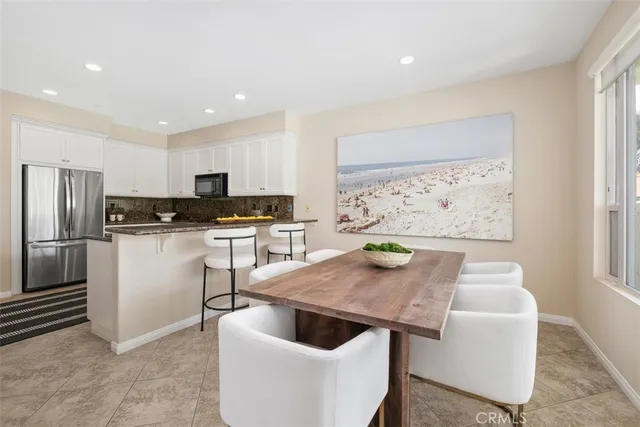 a kitchen with a refrigerator and a stove top oven