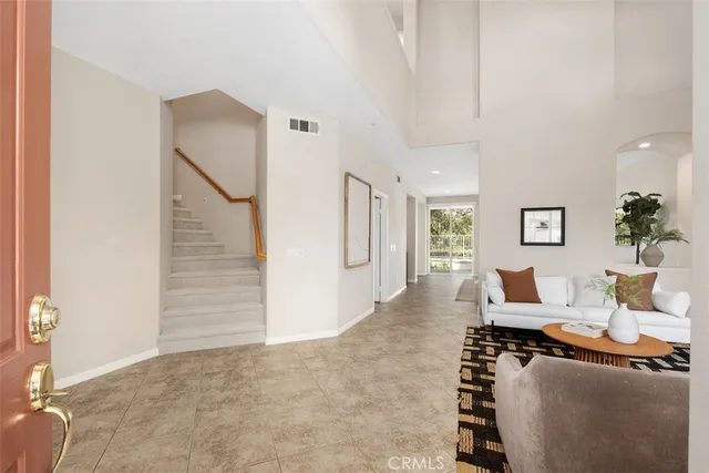 a spacious bedroom with a bed and glass window