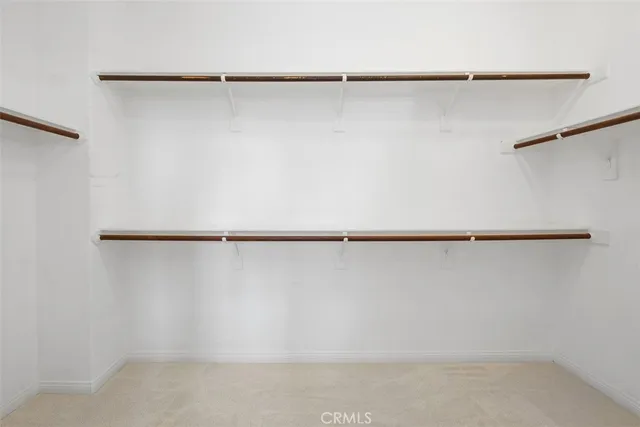 an empty room with closet and windows