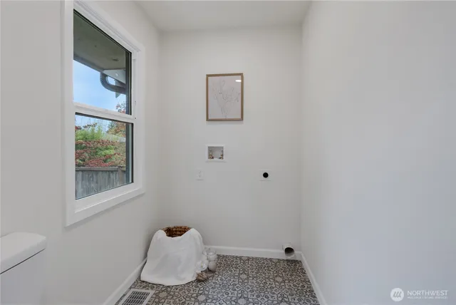 a bathroom with a window and a toilet