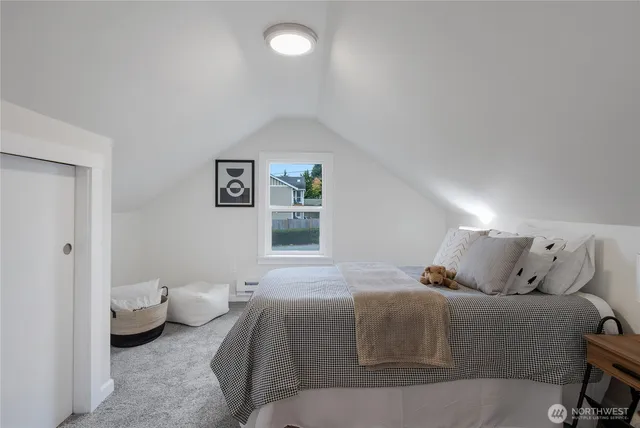 a bedroom with a bed and a lamp