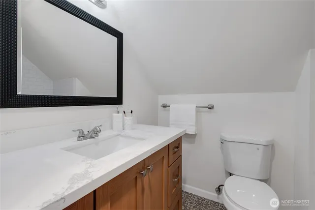 a bathroom with a sink a toilet and mirror