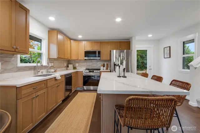 a kitchen with a sink appliances and cabinets